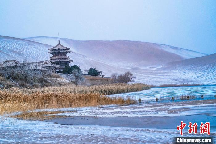 2021年11月28日，雪落鳴沙山月牙泉景區(qū)?！⊥醣筱y 攝